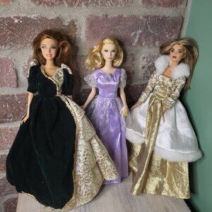 3 Barbie dolls wearing different dresses
